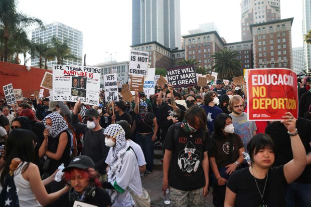 Attendees listen to a speaker during a protest in Los Angeles