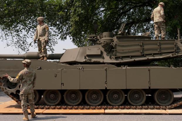 U.S. Army soldiers work on an M1 Abrams tank staged in West Potomac Park ahead of an upcoming military parade